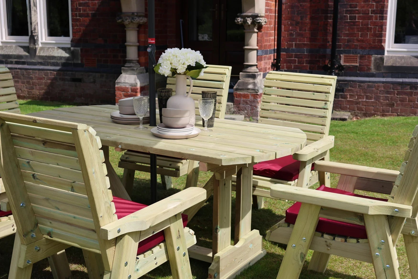 Close view of the Heritage Tanalised rectangular dining table and cushioned chairs