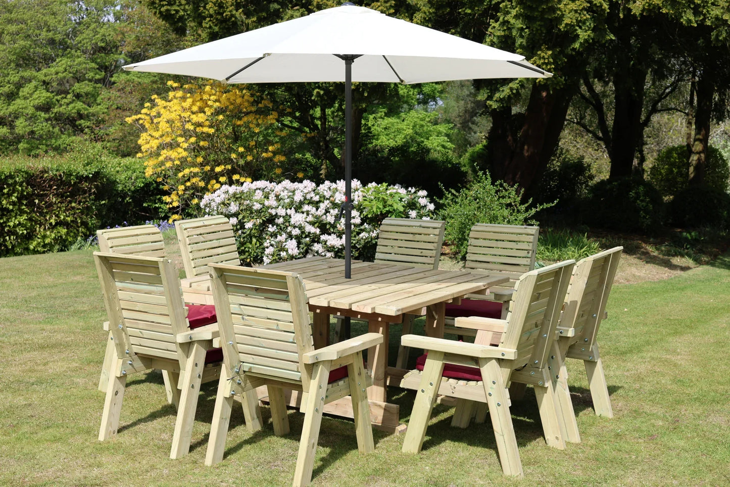 Heritage Tanalised eight chair square dining set in a garden with parasol