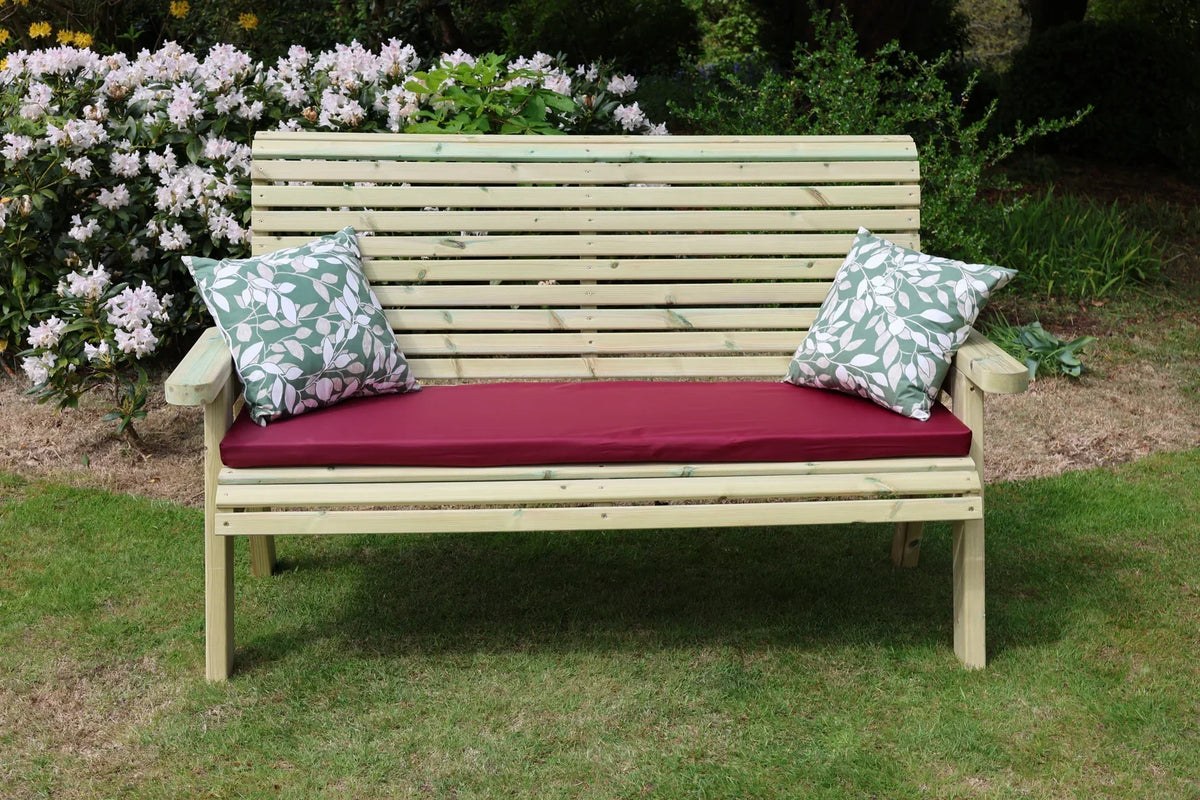 Front view of Heritage Tanalised 3 seat bench with cushion and pillows